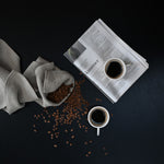 Two 101 Copenhagen Native Coffee Cups with coffee and coffee beans