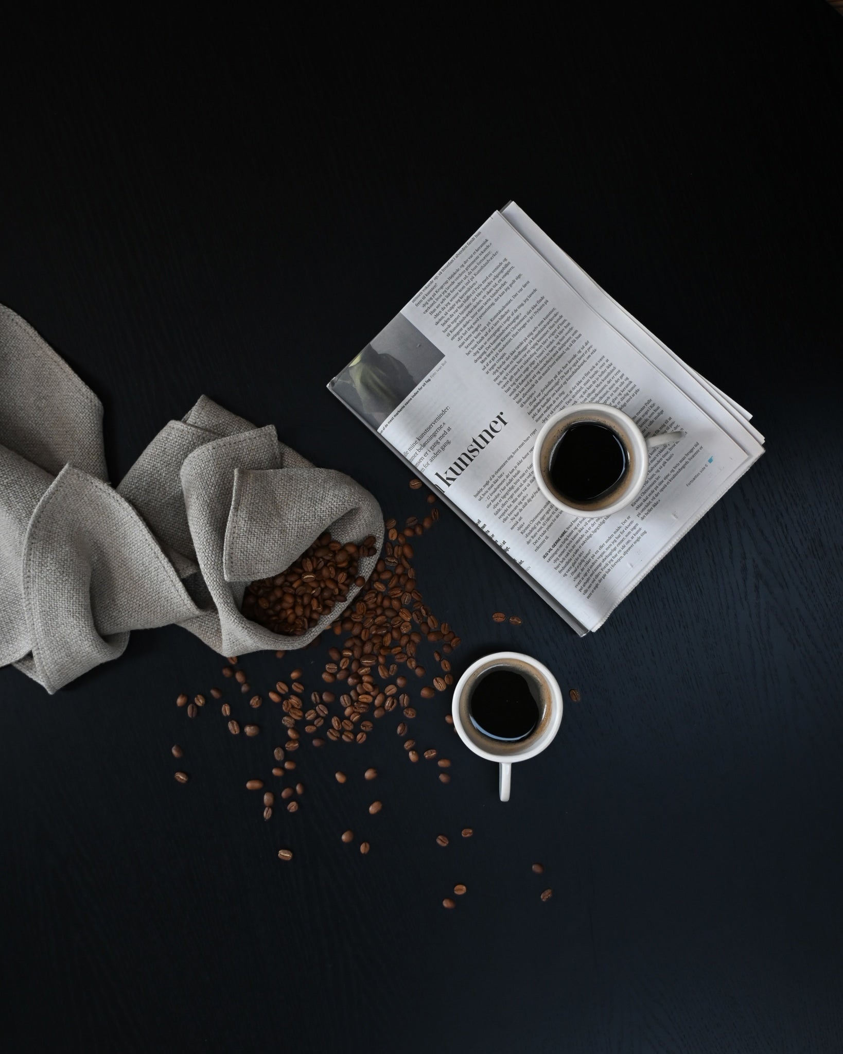 Two 101 Copenhagen Native Coffee Cups with coffee and coffee beans