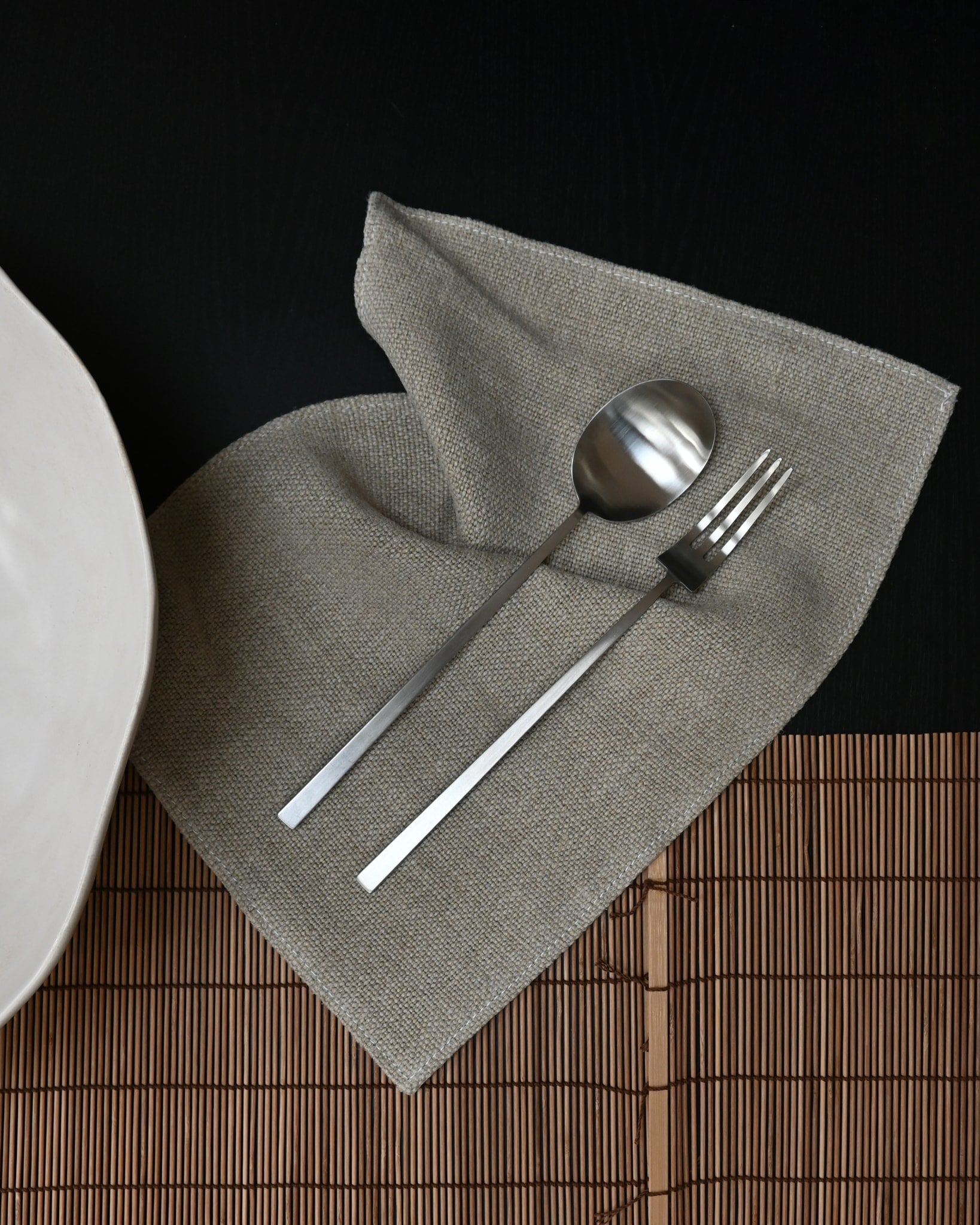 101 Copenhagen Kogei Salad Servers - Brushed Steel on Napkin