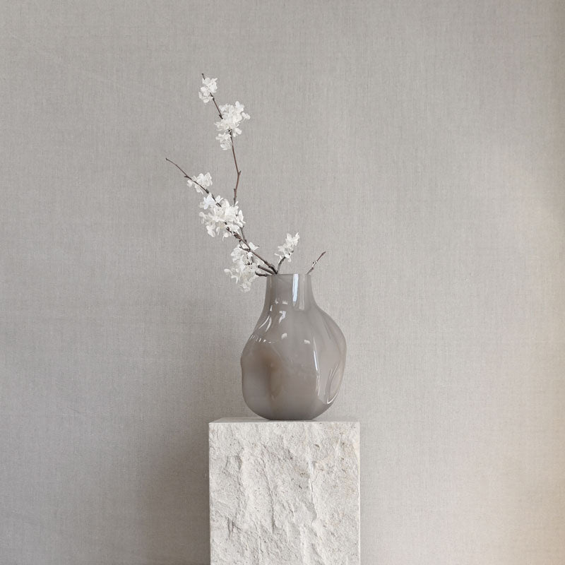 101 Copenhagen Bakku vase in Smoked Desert on Limestone podium