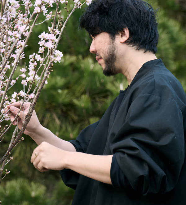 Hikaru Seino adjusting a floral branch