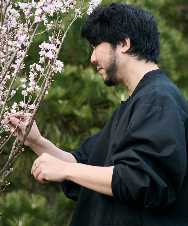 Hikaru Seino adjusting a floral branch