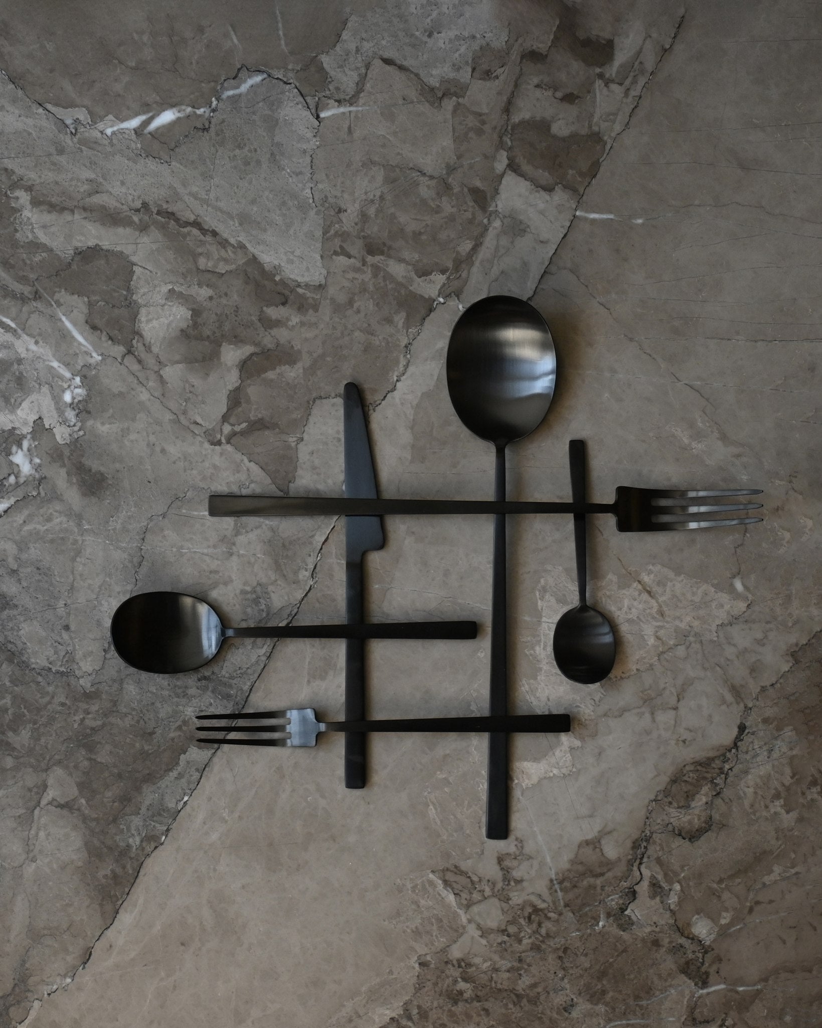 101 Copenhagen Kogei Salad Servers and cutlery - Black on light marble