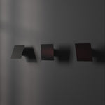 3 directions of Chameleon Wall lamp in Burned black, lit and off.